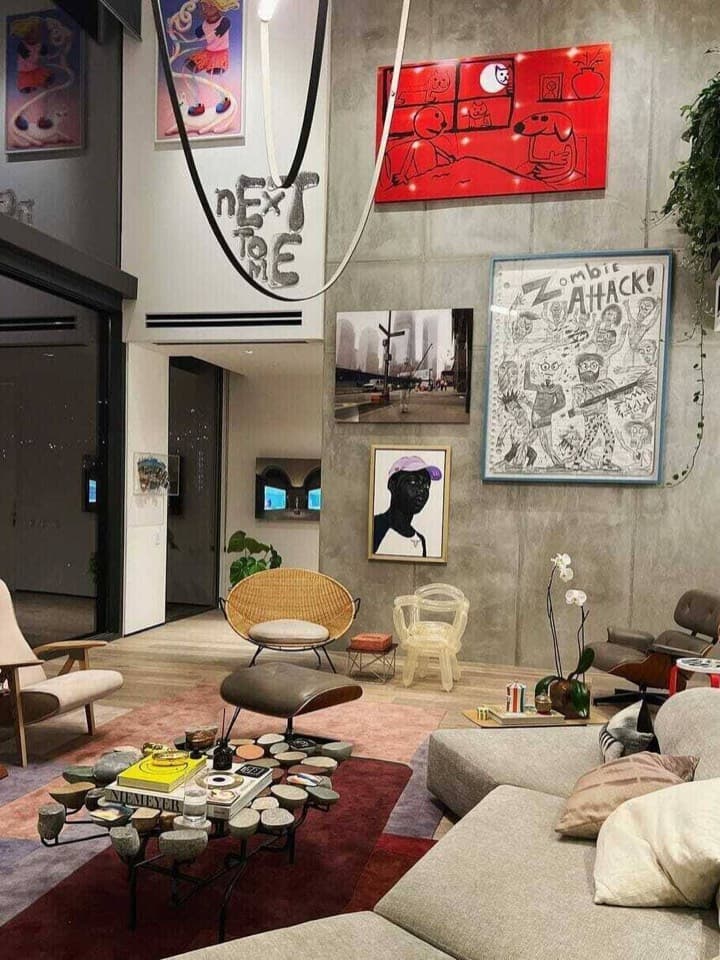 A hotel lounge with designer chairs and artwork