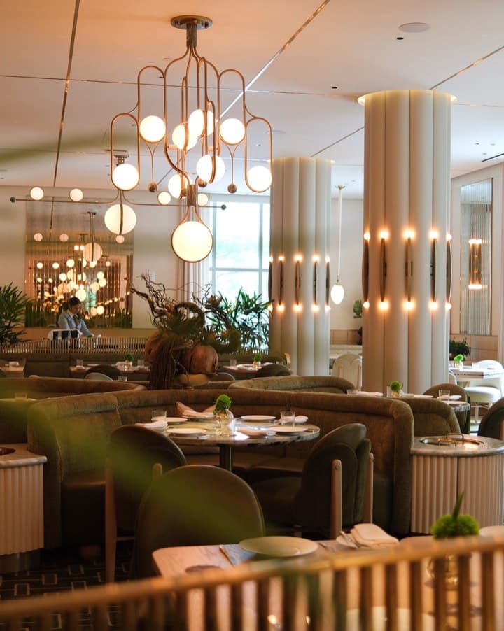 A hotel restaurant with pendant lamps and columns