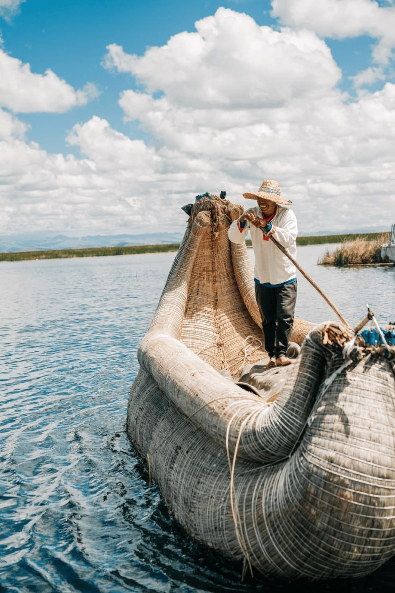 A traveler on a reed boat on a lake
