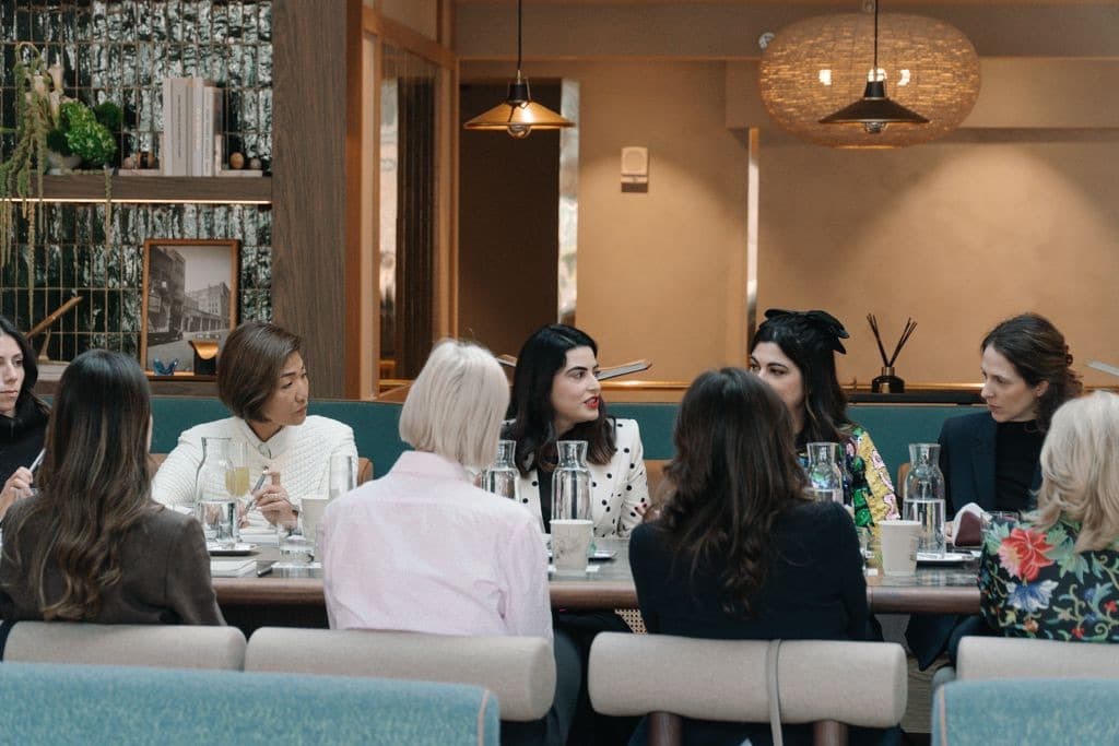 Women seated around a restaurant table, seen from behind
